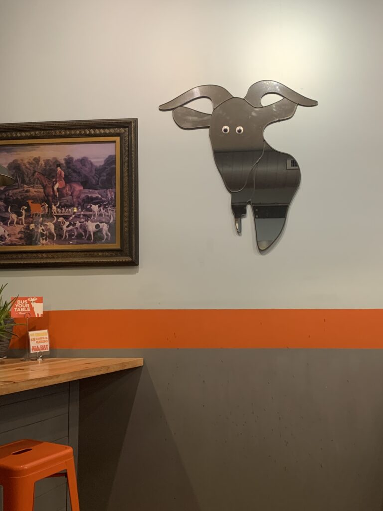 Wall art at Taco Billy with Goat Mirror with googly eyes