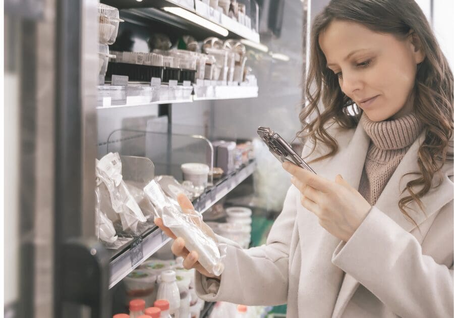 Woman using phone with label reading app