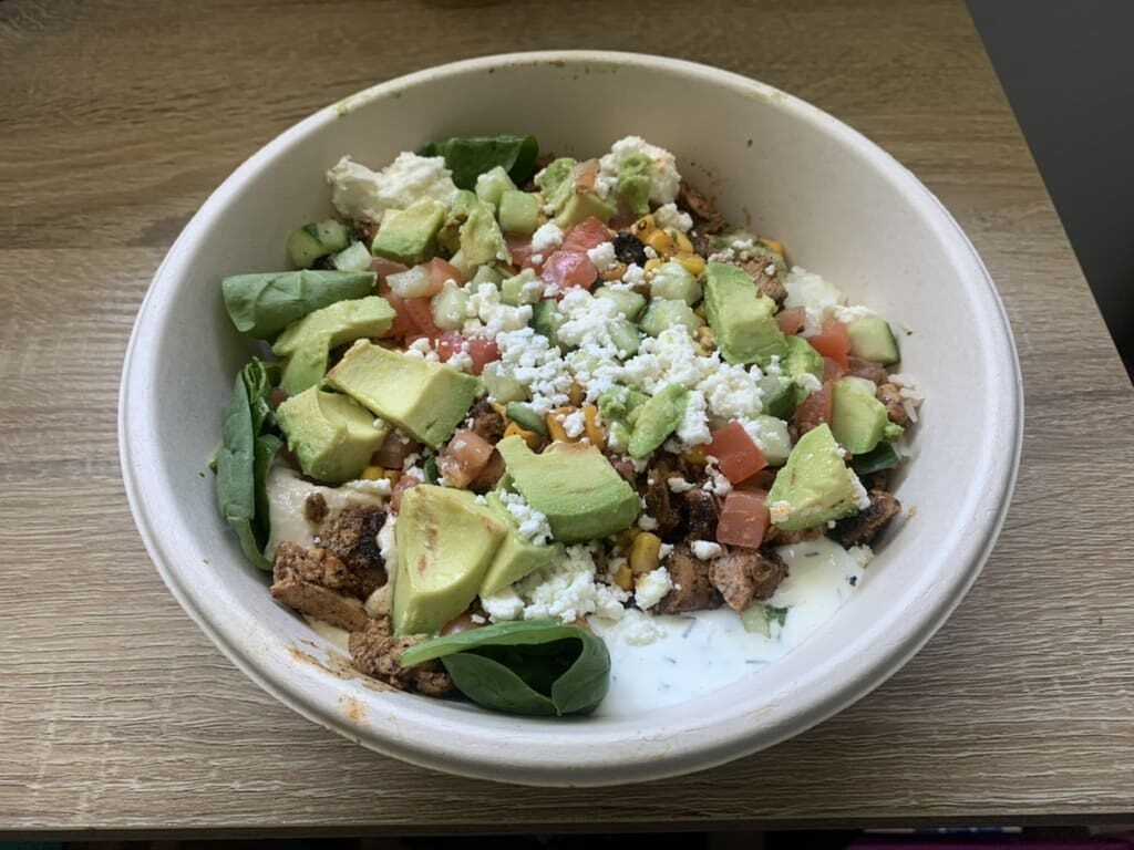 Gluten Free at Cava. Chicken bowl with spimach, rice, feta, avocado, corn, tomato and cucumber